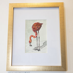 Framed art print featuring a watercolor-style flamingo illustration, mounted in a textured gold frame with a white mat.