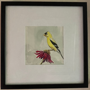 Framed wall art featuring a small bird perched on a red flower, shown in a black frame with a wide white mat.